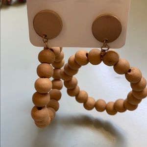 Wood bead hoop earring.